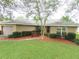 Charming single-story home featuring a well-manicured lawn, tidy landscaping, and inviting front entrance at 5083 Se 26Th St, Ocala, FL 34480
