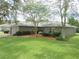 The exterior of this single story home features lush landscaping with a quaint bench and inviting walkway at 5083 Se 26Th St, Ocala, FL 34480