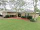 Cozy single-story home with a well-manicured front yard, mulch and an inviting bench at 5083 Se 26Th St, Ocala, FL 34480