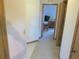 Hallway with neutral colored walls and tan carpet that leads to the bedroom at 5083 Se 26Th St, Ocala, FL 34480
