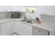 Bright kitchen featuring white cabinets, stainless steel appliances, and ample counter space at 5083 Se 26Th St, Ocala, FL 34480