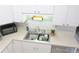 Bright and functional kitchen features white cabinets, double stainless steel sink, and ample counter space at 5083 Se 26Th St, Ocala, FL 34480