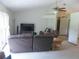 Bright living room featuring a high ceiling, fan, and comfortable seating area for relaxation at 5083 Se 26Th St, Ocala, FL 34480