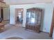 Well-lit living room showcases an elegant china cabinet and view into the dining area at 5083 Se 26Th St, Ocala, FL 34480