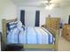 Spacious main bedroom with a ceiling fan and wooden furnishings at 5083 Se 26Th St, Ocala, FL 34480
