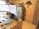 Features a large desk with computer setup and a gun safe, offering a secure workspace at 5083 Se 26Th St, Ocala, FL 34480