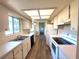 Bright eat-in kitchen features white cabinets, appliances and laminate flooring at 5110 Nw 19Th Pl, Ocala, FL 34482
