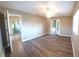Open living room features wood-look flooring and a ceiling fan at 5110 Nw 19Th Pl, Ocala, FL 34482