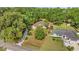 Aerial view of a home, outlined in red, nestled among lush greenery with a long driveway at 5174 Se 41St Ave, Ocala, FL 34480