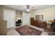 Bedroom features a ceiling fan, desk, closet, and a decorative Persian-style rug at 5174 Se 41St Ave, Ocala, FL 34480