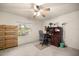 Bedroom featuring a ceiling fan, desk, shelving, and a window providing natural light at 5174 Se 41St Ave, Ocala, FL 34480