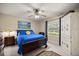 Bedroom with decorative wardrobe, ceiling fan, dark wood furniture, and natural light at 5174 Se 41St Ave, Ocala, FL 34480