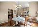 Cozy dining area featuring hardwood floors, chandelier lighting, and a view into the living room at 5174 Se 41St Ave, Ocala, FL 34480