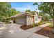 Exterior side view of house featuring a driveway, garage, and partial landscaping at 5174 Se 41St Ave, Ocala, FL 34480