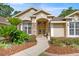 Inviting front entrance with double doors, stone accents, and well-maintained landscaping at 5174 Se 41St Ave, Ocala, FL 34480
