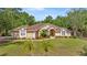 Charming single-story home featuring a well-manicured lawn, mature landscaping, and inviting curb appeal at 5174 Se 41St Ave, Ocala, FL 34480
