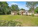 Charming single-story home featuring a well-manicured lawn and mature trees at 5174 Se 41St Ave, Ocala, FL 34480