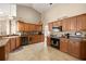 Well-equipped kitchen featuring oak cabinets, tile floors, and ample counter space at 5174 Se 41St Ave, Ocala, FL 34480