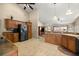 Functional kitchen showcasing dark appliances, wood cabinets, and tile flooring at 5174 Se 41St Ave, Ocala, FL 34480