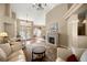 Spacious living room showcasing a fireplace, chandelier, and access to the dining area at 5174 Se 41St Ave, Ocala, FL 34480