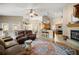 Open concept living room with fireplace flowing into the kitchen at 5174 Se 41St Ave, Ocala, FL 34480