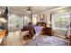 Serene primary bedroom featuring a four-poster bed, hardwood floors, and access to the patio at 5174 Se 41St Ave, Ocala, FL 34480