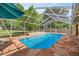 Bright in-ground screened pool boasts stone-look patio, water feature and backyard views at 5174 Se 41St Ave, Ocala, FL 34480