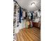 Walk-in closet featuring organization shelving and wood floors at 5174 Se 41St Ave, Ocala, FL 34480