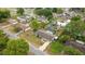Aerial view of a single-Gathering home featuring a screened-in pool, fenced in back yard, and mature landscaping at 5720 Se 20Th St, Ocala, FL 34480
