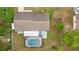 Aerial view showcases a home with a swimming pool and a well-maintained yard at 5720 Se 20Th St, Ocala, FL 34480