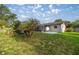 Backyard features a screened pool, tropical plants, and a single-story home with a neutral color at 5720 Se 20Th St, Ocala, FL 34480