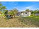 View of screened-in pool with privacy fence and mature tropical foliage and plants at 5720 Se 20Th St, Ocala, FL 34480