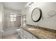 Bathroom boasts granite counters, tile shower, and a large mirror at 5720 Se 20Th St, Ocala, FL 34480