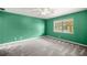 Bright bedroom with neutral carpet, ceiling fan, and natural light from window at 5720 Se 20Th St, Ocala, FL 34480