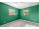 Bedroom with neutral carpet, ceiling light, and natural light from two windows at 5720 Se 20Th St, Ocala, FL 34480