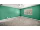 Bright bedroom featuring neutral carpet, a ceiling fan, and a window for natural light at 5720 Se 20Th St, Ocala, FL 34480