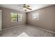 Cozy bedroom featuring plush carpeting and natural light filtering through two windows at 5720 Se 20Th St, Ocala, FL 34480