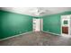Spacious bedroom featuring neutral carpet, a ceiling fan, and an ensuite bathroom at 5720 Se 20Th St, Ocala, FL 34480