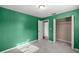 Bright bedroom with green walls, closet, and a doorway that leads to another room at 5720 Se 20Th St, Ocala, FL 34480