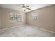 A light-filled bedroom with two windows and neutral carpet at 5720 Se 20Th St, Ocala, FL 34480