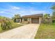 Charming single Gathering home with stone accents, attached garage, manicured lawn, and a long driveway at 5720 Se 20Th St, Ocala, FL 34480