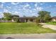 Single story home with a large front lawn and concrete driveway at 5720 Se 20Th St, Ocala, FL 34480