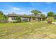 Charming single-story home featuring a well-maintained front yard, stone accents, and an attached garage at 5720 Se 20Th St, Ocala, FL 34480