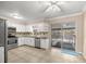 Bright kitchen with white cabinets, stainless steel appliances, and sliding doors to the pool area at 5720 Se 20Th St, Ocala, FL 34480
