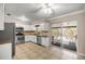 Bright kitchen with stainless steel appliances and a sliding glass door to the screened pool at 5720 Se 20Th St, Ocala, FL 34480