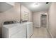 Bright laundry room with tile floor, washer and dryer, and large window at 5720 Se 20Th St, Ocala, FL 34480