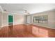 Spacious living room featuring hardwood floors and a large window for natural light at 5720 Se 20Th St, Ocala, FL 34480