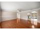 Spacious living room with hardwood floors, and access to the kitchen and pool area at 5720 Se 20Th St, Ocala, FL 34480
