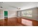 Living room with hardwood floors, large window and freshly painted walls at 5720 Se 20Th St, Ocala, FL 34480