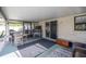 Covered patio with an outdoor seating area, a bar, and a sliding glass door at 5720 Se 20Th St, Ocala, FL 34480